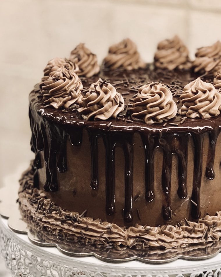 A chocolate layer cake with ganache drip
