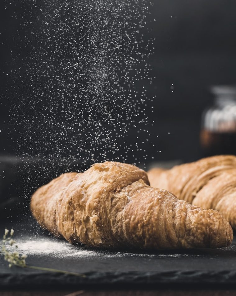 Butter croissants dusted with icing sugar